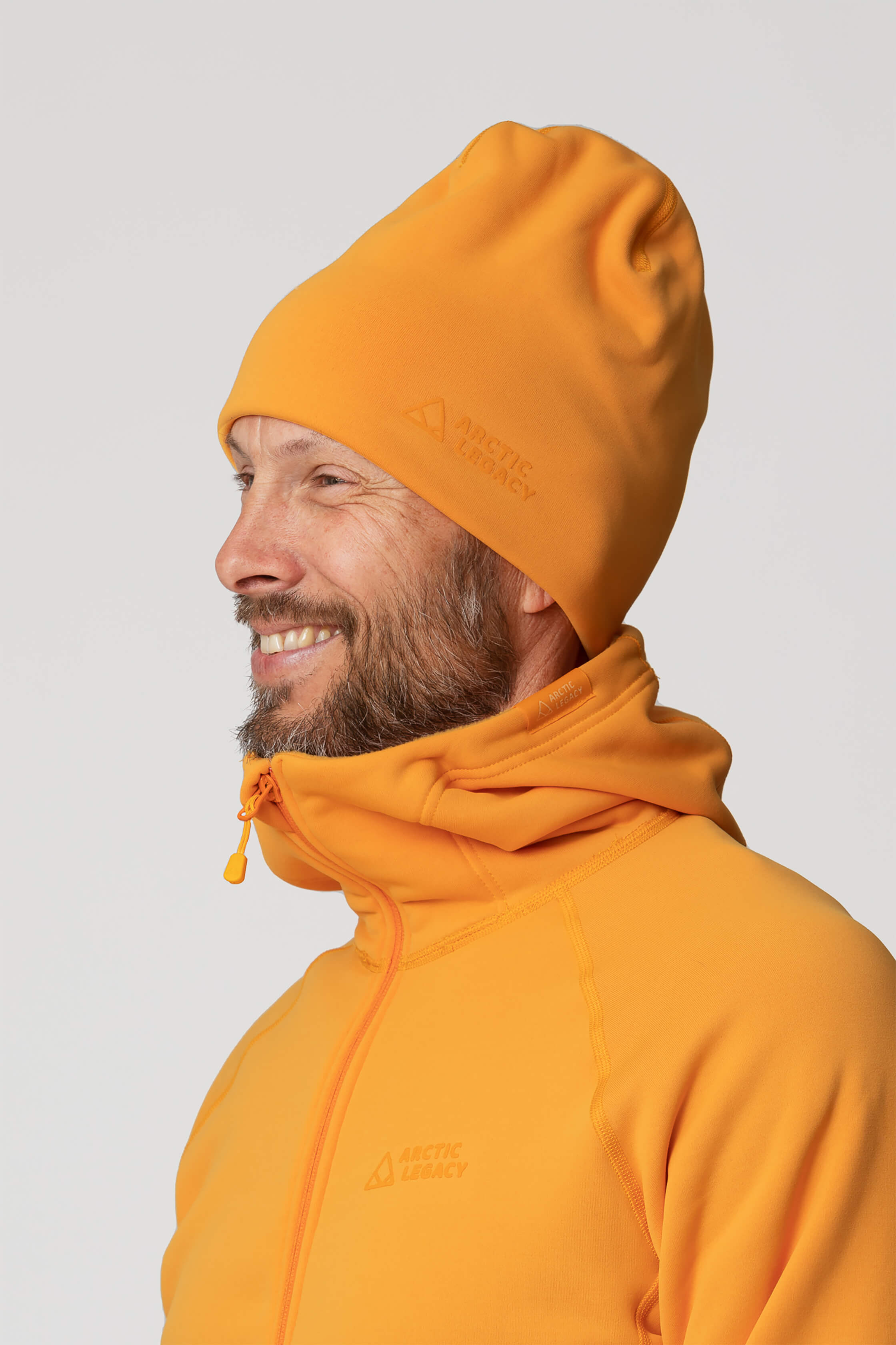 Orange yellow fleece hat - side view of the Arctic Legacy Nova Dual Layer Beanie#color_zinnia