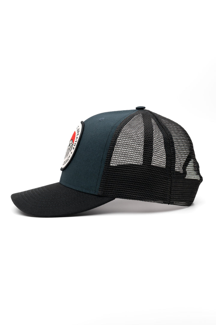 Blue and black trucker hat - left side view of the Arctic Legacy Europe Trucker Hat#color_night-blue-black