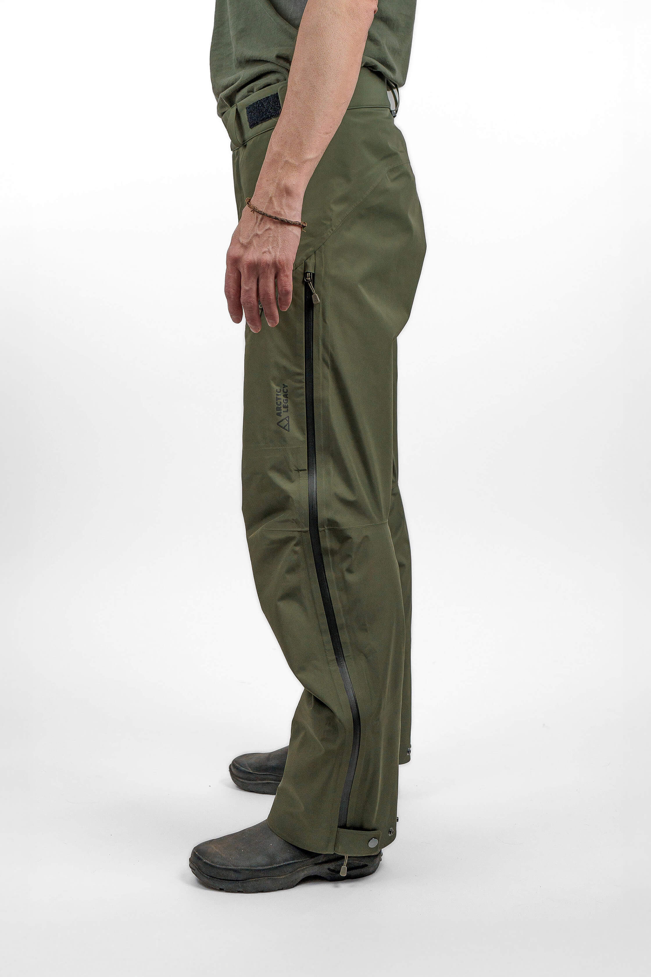 Green hardshell pants in unisex sizing - side view of the Arctic Legacy Nuka Elements 3 layer Pants#color_dusty-olive
