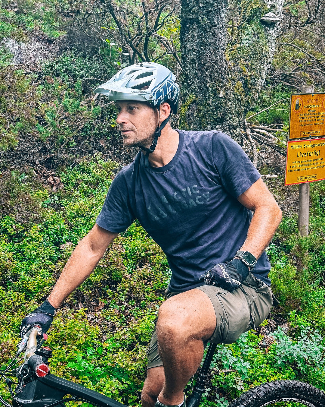 Men's blue t-shirt - on the bike front view of the Arctic Legacy Milo Organic Tee#color_dark-navy