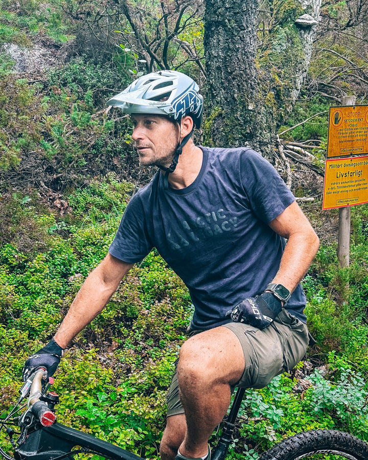 Men's blue t-shirt - on the bike front view of the Arctic Legacy Milo Organic Tee#color_dark-navy