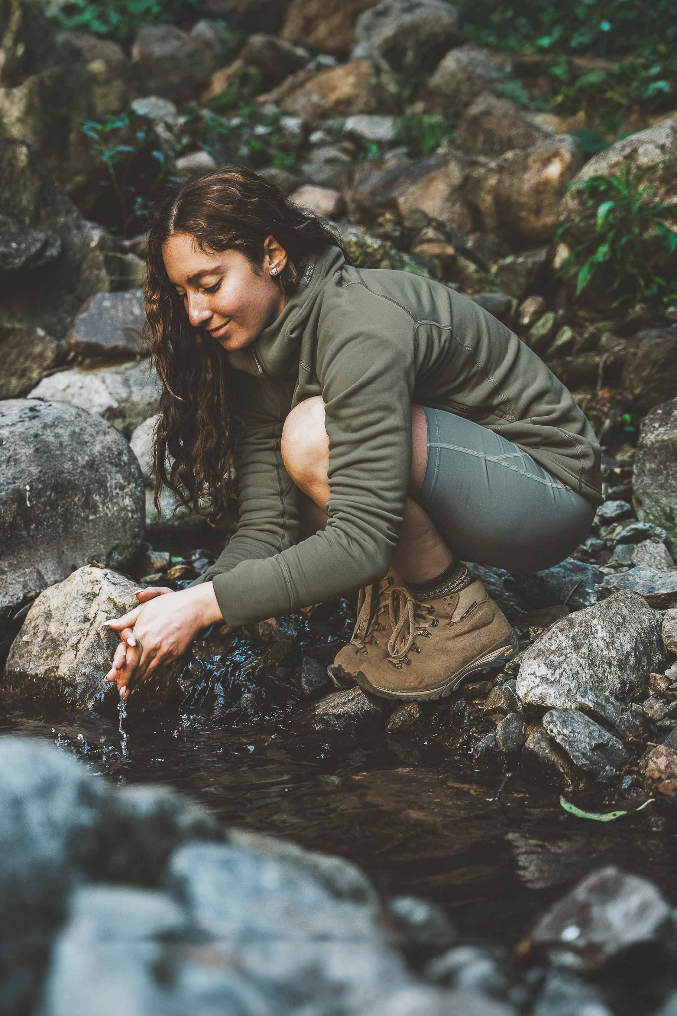 A picture of a woman wearing the Nanuk Pro Fleece Hoodie from Arctic Legacy