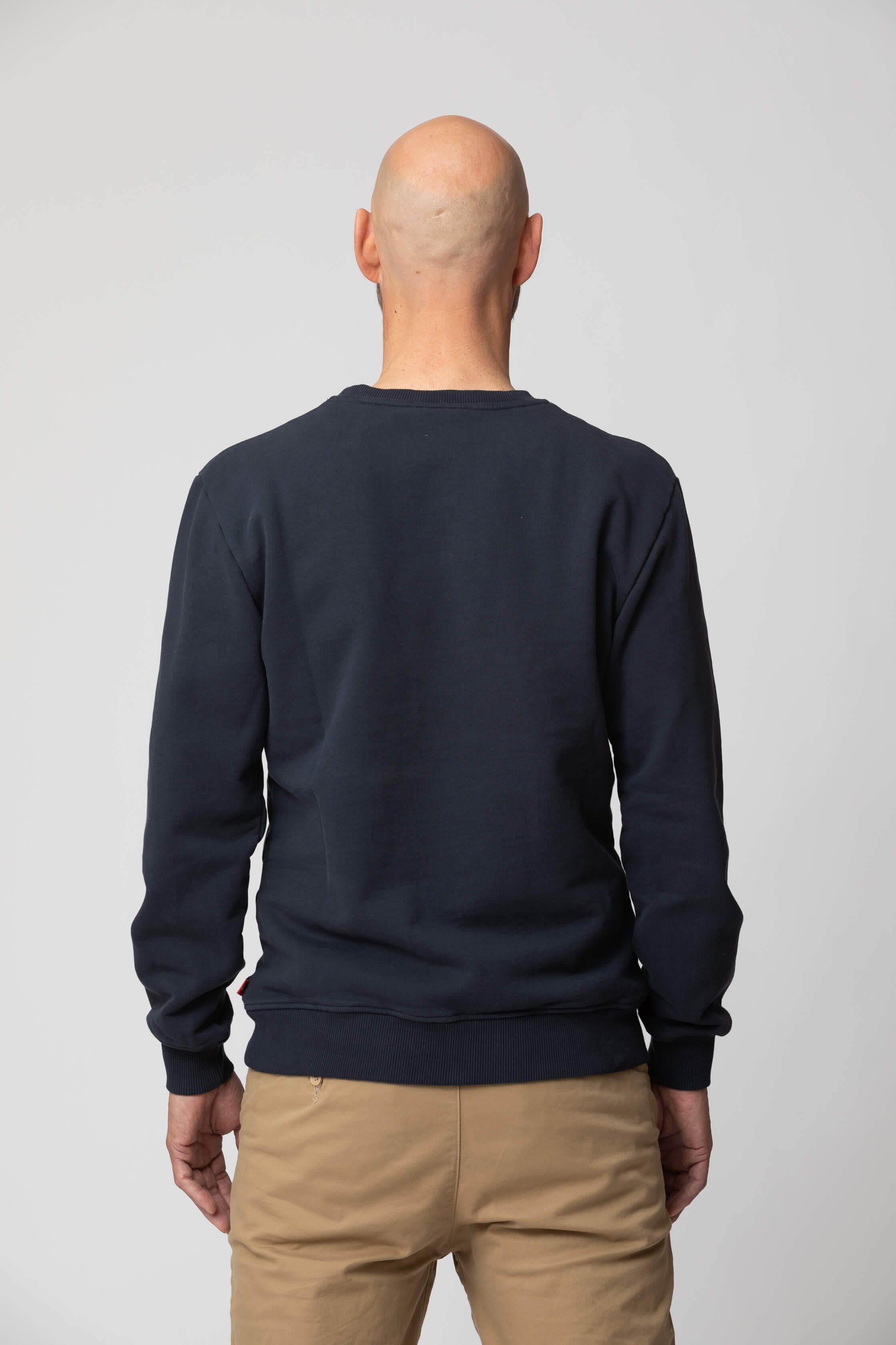 Men’s blue sweatshirt - back view of the Arctic Legacy Ember Organic Crew Sweater#color_dark-navy