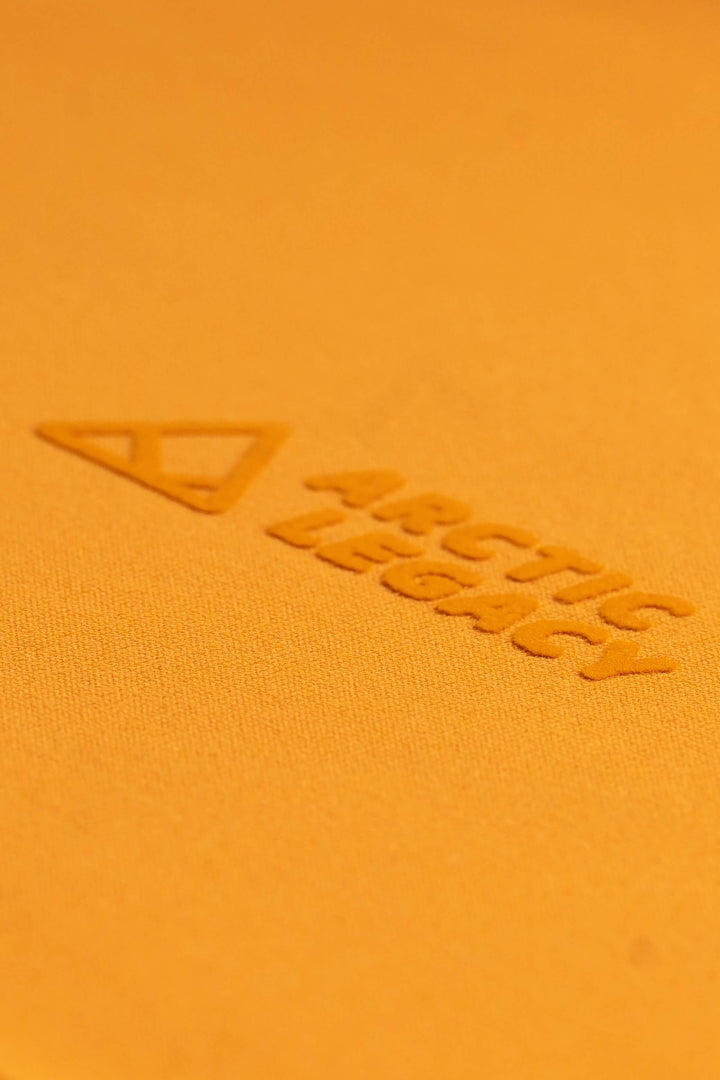Women's orange yellow fleece jacket - close-up view of the Arctic Legacy Nanuk Pro Fleece Hoodie#color_zinnia