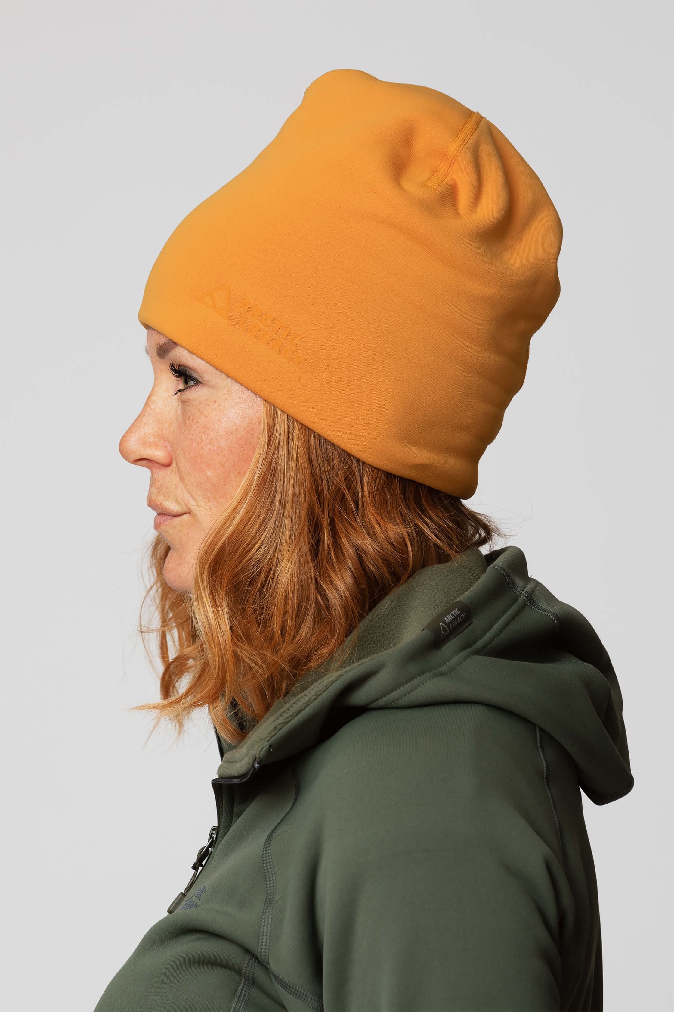 Orange yellow fleece hat - side view of the Arctic Legacy Nova Dual Layer Beanie#color_zinnia