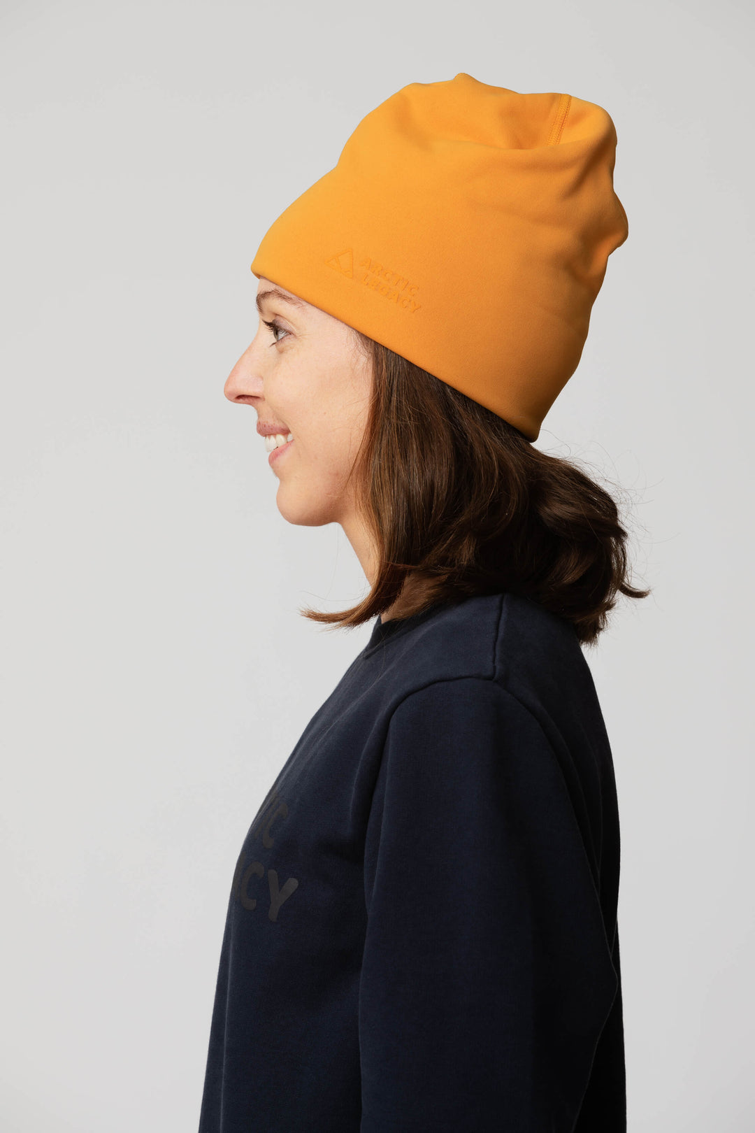 Orange yellow fleece hat - side view of the Arctic Legacy Nova Dual Layer Beanie#color_zinnia