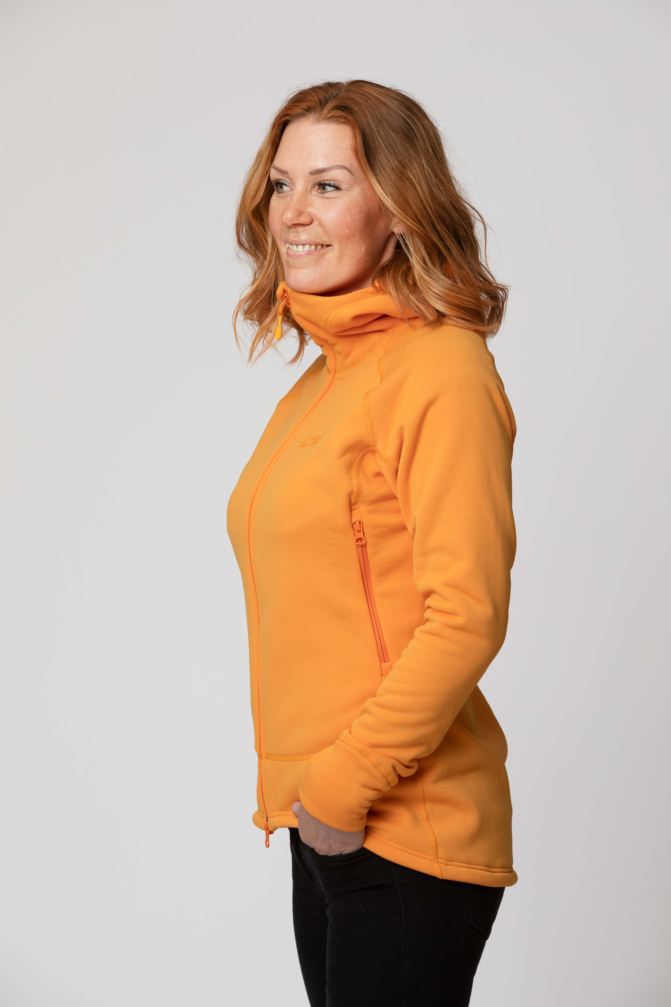 Women's orange yellow fleece jacket - side view of the Arctic Legacy Nanuk Pro Fleece Hoodie#color_zinnia