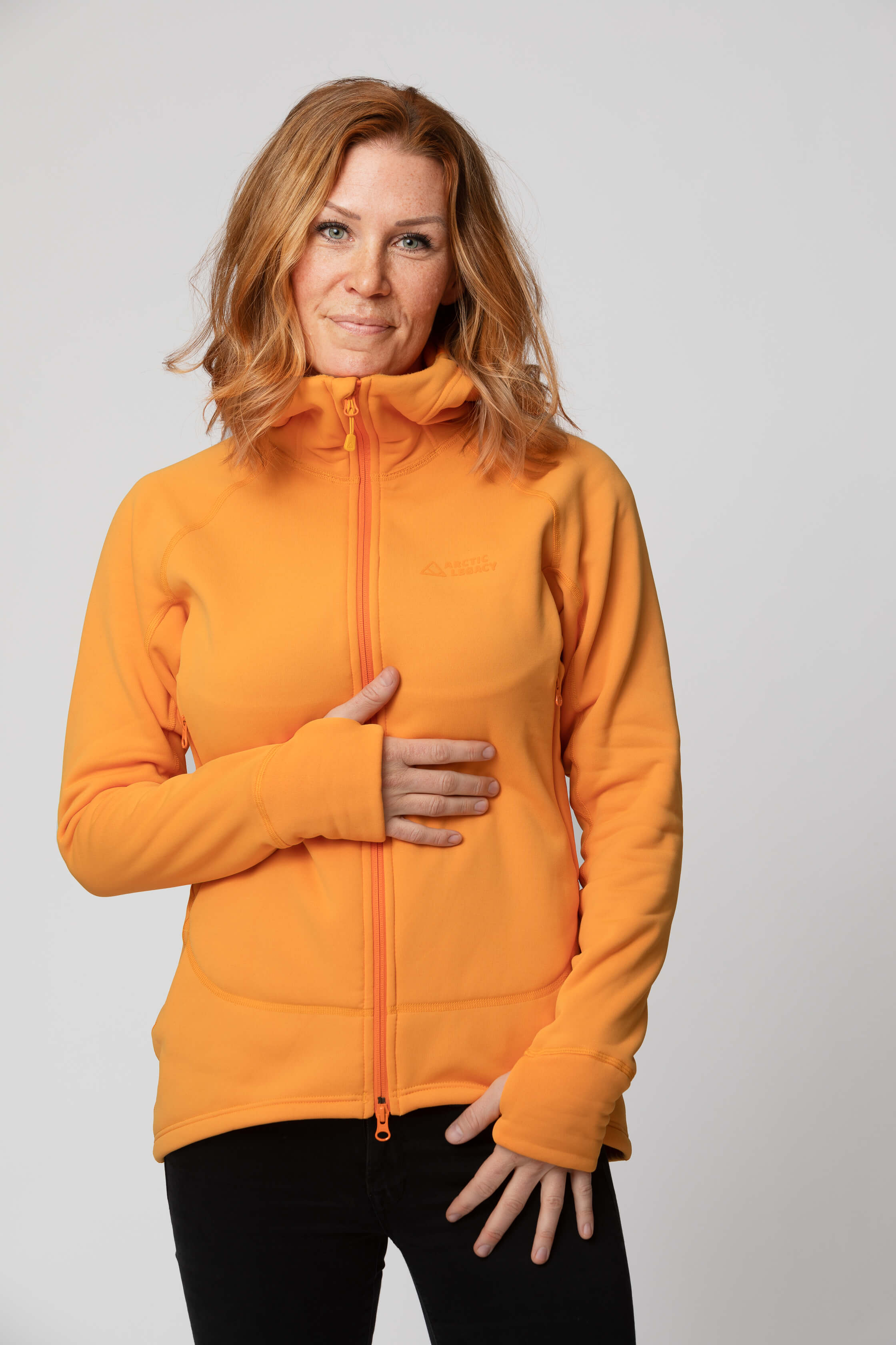 Women's orange yellow fleece jacket - front view of the Arctic Legacy Nanuk Pro Fleece Hoodie#color_zinnia